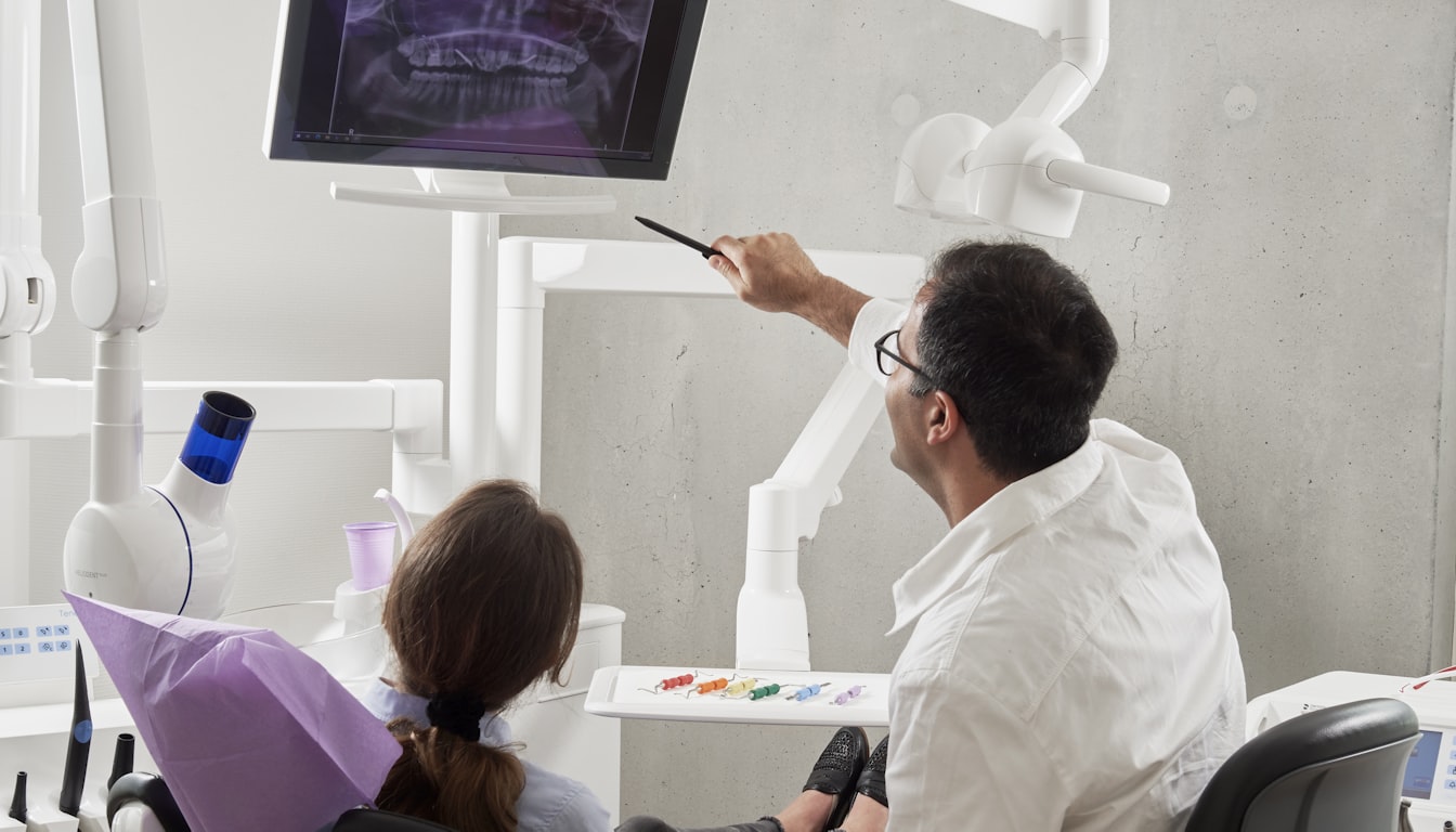 Dentist reviewing a dental X-ray with a patient